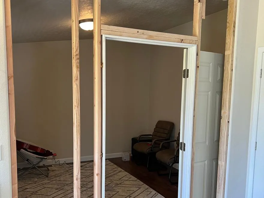 A new interior wall framed in place, with the door opening set