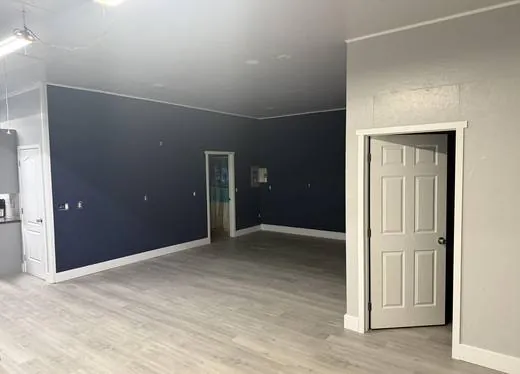 Shop converted into finished living space with a navy accent wall