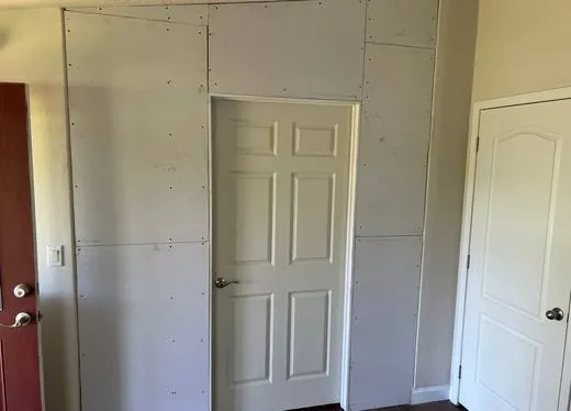 A new interior wall drywalled and ready for finish work