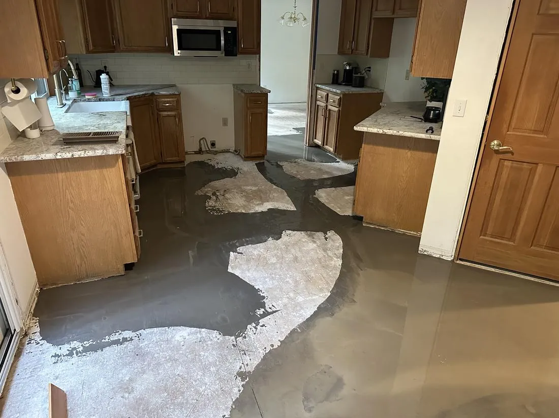 Self-leveling compound poured over a damaged kitchen subfloor