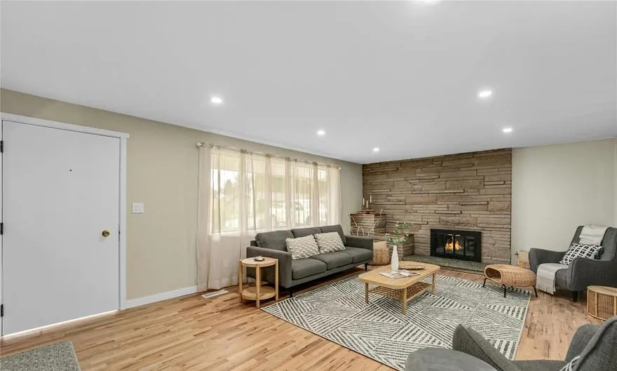 Living room after a whole-home remodel in Kent, with hardwood floors and a wood accent wall